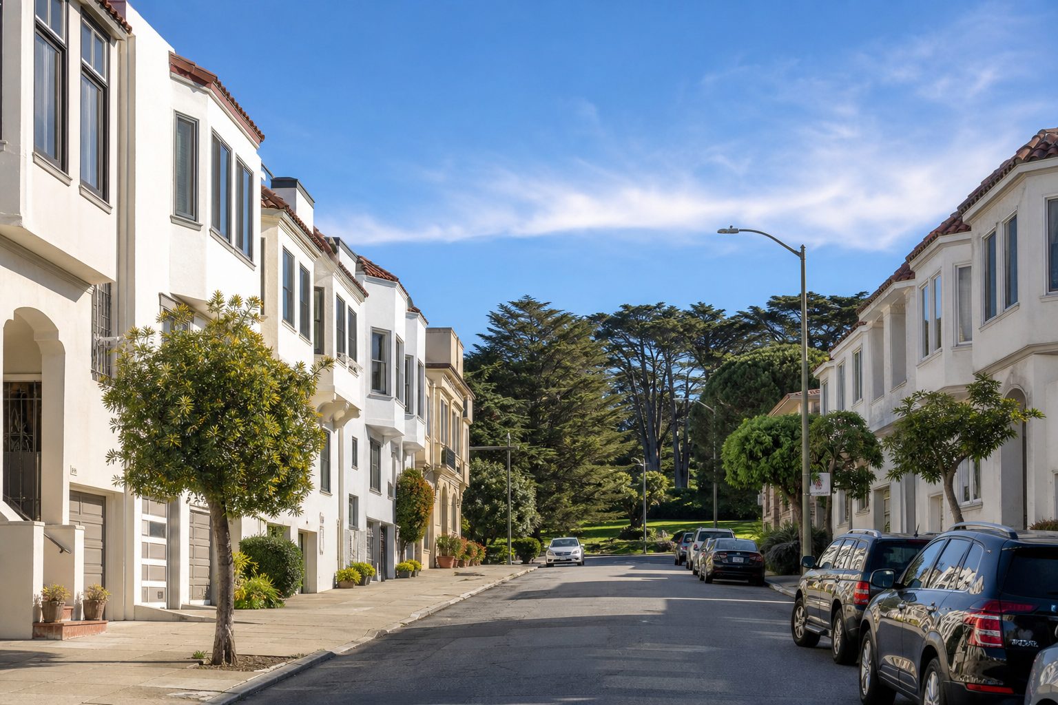 Row of white stucco houses on an Inner Richmond street in San Francisco